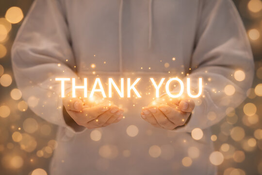 Thank you message and appreciation concept. A person holds a glowing "Thank You" message, symbolizing gratitude, appreciation, and congratulations in personal or business interactions.