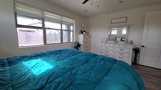 Bright turquoise bedroom with natural light and decorative accents