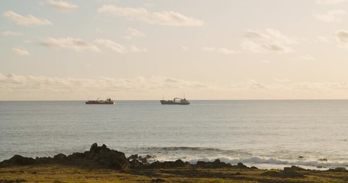 Fishing boats in the coast of Ahu Tahai, Hanga Roa, Easter Island during sunset