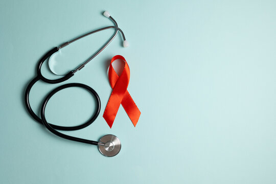 Red awareness ribbon symbolizing the fight against HIV and AIDS, solidarity with people living with HIV and remembrance