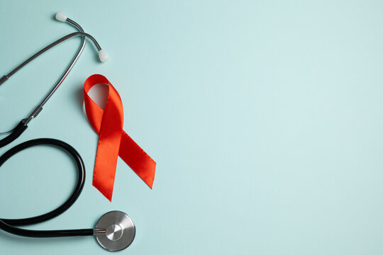 Red awareness ribbon symbolizing the fight against HIV and AIDS, solidarity with people living with HIV and remembrance