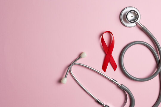 Red awareness ribbon symbolizing the fight against HIV and AIDS, solidarity with people living with HIV and remembrance