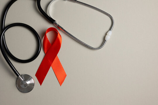 Red awareness ribbon symbolizing the fight against HIV and AIDS, solidarity with people living with HIV and remembrance