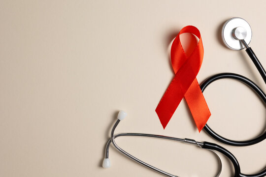 Red awareness ribbon symbolizing the fight against HIV and AIDS, solidarity with people living with HIV and remembrance