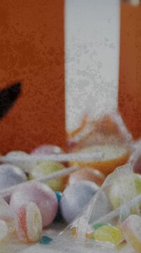 Grunge textured effect over halloween candies and scary pumpkin printed bags on white background
