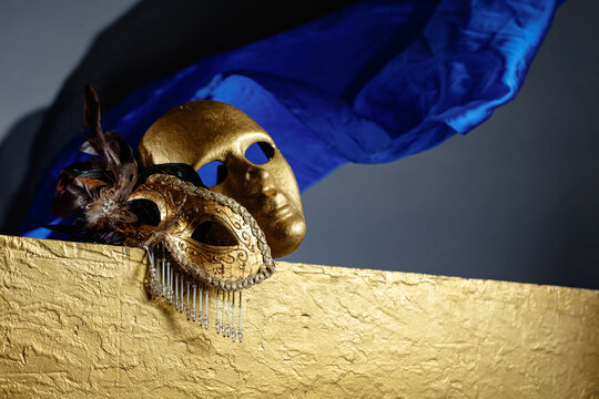 Golden carnival masks on a gold background.