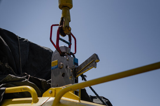 The Fast Rescue Craft connected to the  FRC davit through the quick release hook. The lifting device is used to securely grip and handle FRC lowering