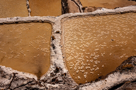 A close-up showing the natural texture of the salt in the Maras salt pans, Peru.
