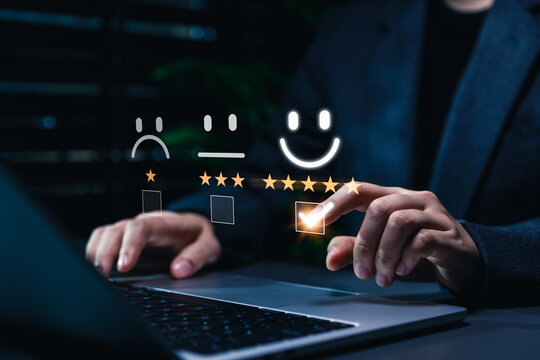 Customer satisfaction feedback and rating concept. Businesswoman selecting five star happy face rating on survey interface representing customer satisfaction, feedback, user experience, review process