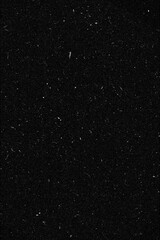 Fototapeta premium Vintage film grain and dust texture overlay on black background