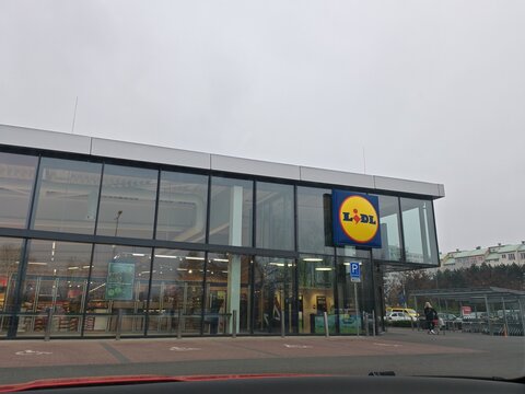Prague,Czech Republic-11 April 2026:supermarket exterior and illuminated retail signage, upper view