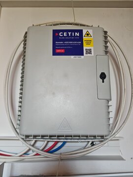 Prague,Czech Republic-31 July 2026:CETIN fiber-optic network distribution box and warning label, context view