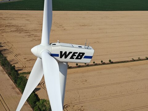 Znojmo,Czech Republic-6 July 2025:WEB wind turbine nacelle and rotor above agricultural fields, wide view