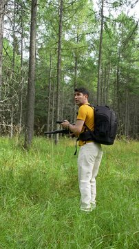 Male Photographer Taking Photos in a Lush Green Forest