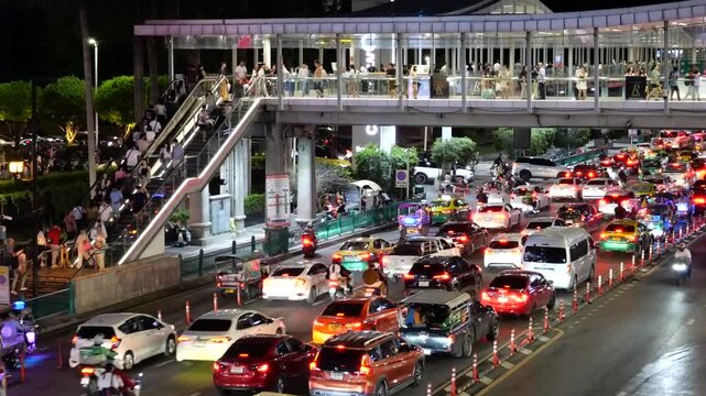 Bangkok traffic, tourists on skywalk and shopping mall area