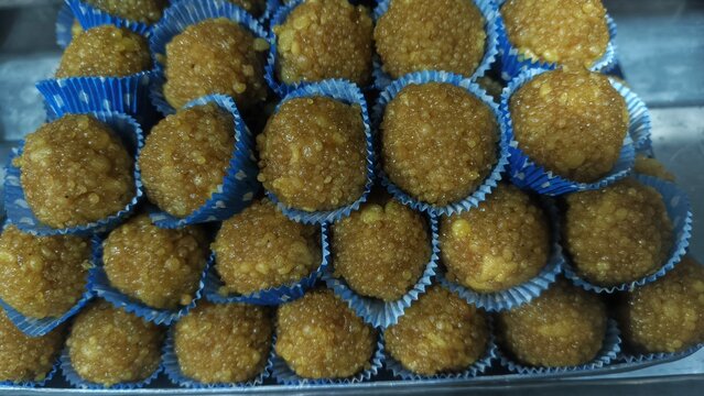 Fresh motichoor laddu sweet balls in blue paper cups
