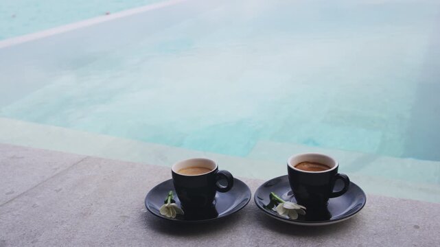 Coffee in espresso cups for two people on luxury pool side on vacation.