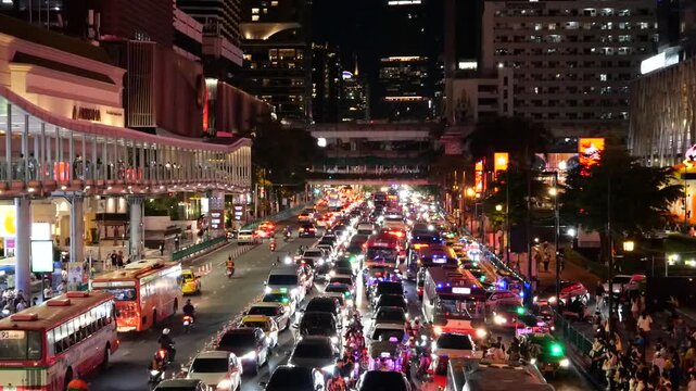 Bangkok traffic, skyscraper, tourists on skywalk and shopping mall area