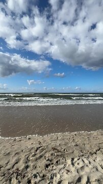 The Baltic Sea in summer, the shore and waves in beautiful, sunny weather.