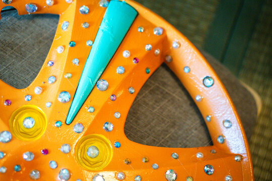 Orange decorative wheel with rhinestones close-up