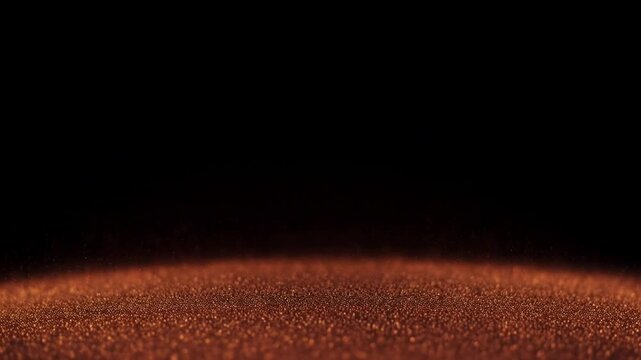Sparkling golden particles dissolving into dark background