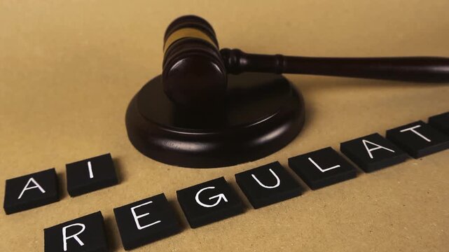 Judge's gavel alongside black letter tiles spelling out AI regulation on a brown surface, symbolizing the ongoing legal and ethical debate surrounding artificial intelligence policies