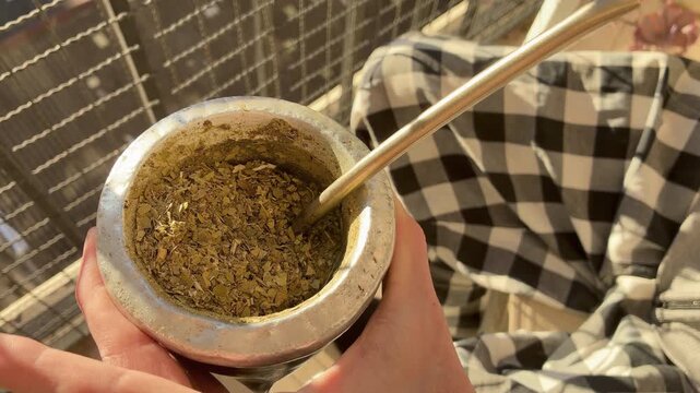 Traditional Argentine Yerba Mate Tea Infusion Warm Drink Lifestyle Scene on terrace, balcony, rooftop Autumn Day, South America. Typical social drink from Argentina, Uruguay, Paraguay and Brazil