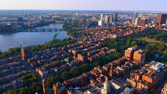 Scenic view on the Back Bay neighborhood with beautiful buildings and lush greenery. Approaching the Charles River waterscape with numerous sailboats on. Boston, Massachusetts, USA.