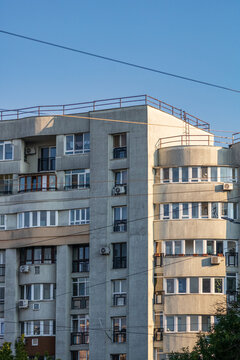 Worn out communist era apartment building with weathered facade and deteriorating residential architecture in Bucharest Romania