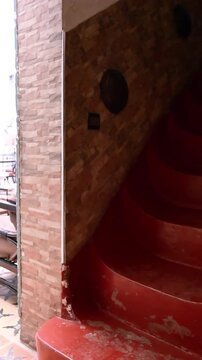 Marrakech, morocco. August 8, 2026. Descending a staircase revealing the serene and empty courtyard of a traditional moroccan riad, featuring ornate tilework and peaceful decor