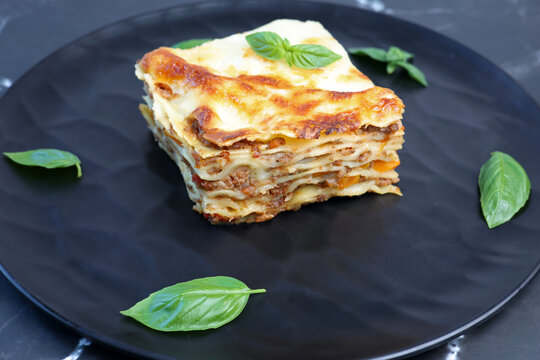 lasagna with basil leaf on plate