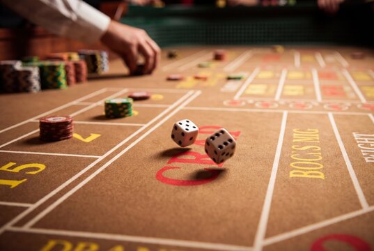 Craps table game rolling dice casino gambling chips stakes luck betting