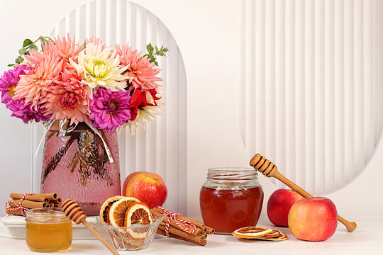 Autumn banner with a beautiful bouquet of dahlias in a vase, honey, apples, dried orange, cinnamon and star anise on an elegant background, autumn greeting and gratitude concept, cozy composition