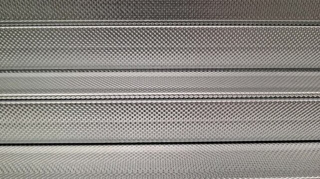 Metal galvanized knurled profiles stacked on top of each other, construction materials, building supply, hardware store.