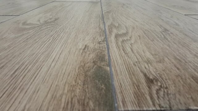 Wood grain flooring fills the frame in close view, natural texture, interior surface, home design, rustic pattern.