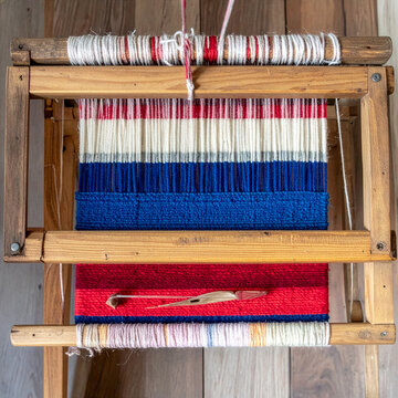 Traditional weaving loom with colorful yarn threads craft handmade closeup