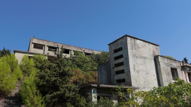Abandoned soviet style cinema building and italian era buildings on Sazan