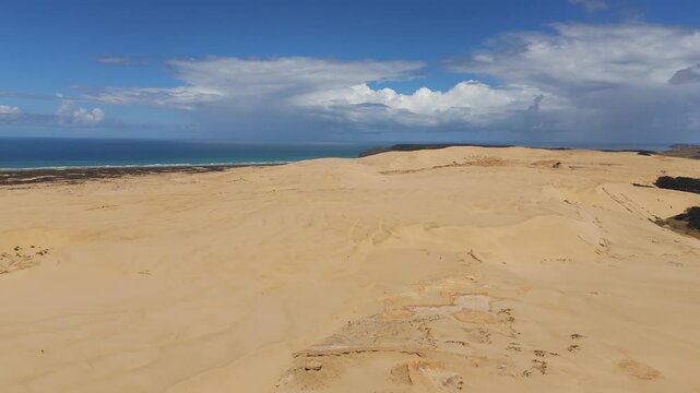 Giant Sand Dunes during the day with sun shining on the Northland Peninsula of New Zealand, wide shot