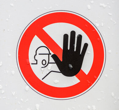 Restricted access prohibition sign with raised stop hand.
