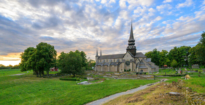 Varnhem, Sweden - August 18 2026: Panoramic sunset landscape around Varnhem Abbey Church and monastery ruins.