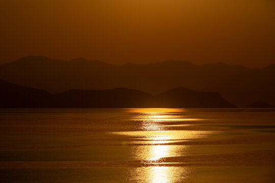 Dramatic reflection of the sunrise on the surface of the sea.