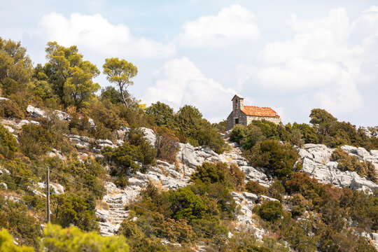 Photogenic little church on top of a rocky ridge overlooking the Adriatic Sea.