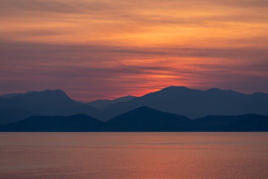 Dramatic morning sky over the sea, seconds before sunrise.