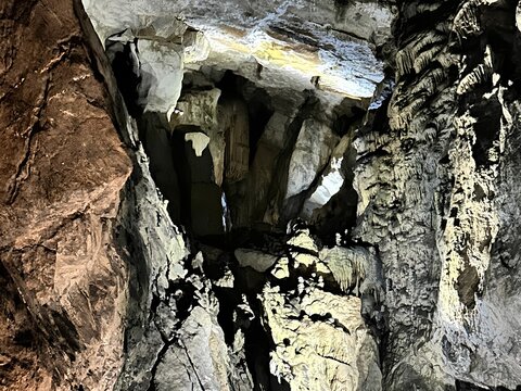 Dramatic low angle view looking up at massive limestone cave rock formations inside a cavern