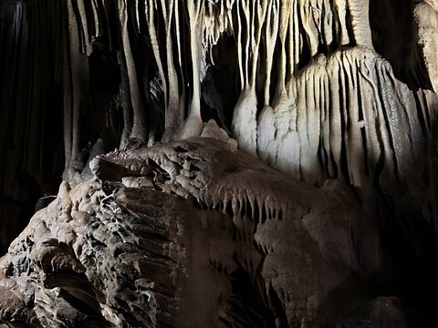 Stunning stalactites and stalagmites rock formations inside a limestone cave chamber