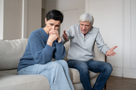 Upset depressed senior woman under verbal abuse during quarrel with frustrated annoyed husband, displeased offensive elderly partner in confrontation with mentally exhausted wife, rudeness in family.