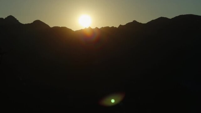 Golden Sunrise Over Mountain Ridge With Sun Flare and Dramatic Silhouette at Dawn from Ravello towards Amalfi Coast Italy