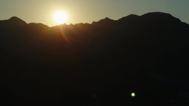 Golden Sunrise Over Mountain Ridge With Sun Flare and Dramatic Silhouette at Dawn from Ravello towards Amalfi Coast Italy