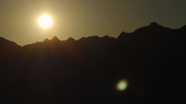 Golden Sunrise Over Mountain Ridge With Sun Flare and Dramatic Silhouette at Dawn from Ravello towards Amalfi Coast Italy