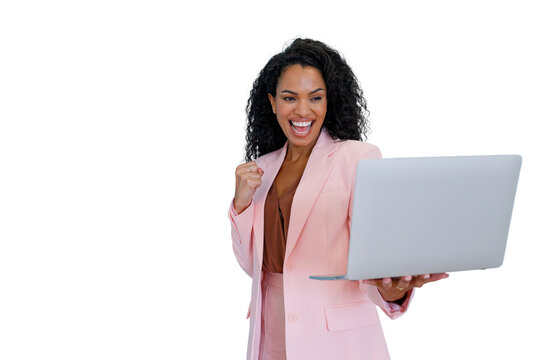 Excited businesswoman cheering with a clenched fist, celebrating great news and professional achievement while looking at her laptop